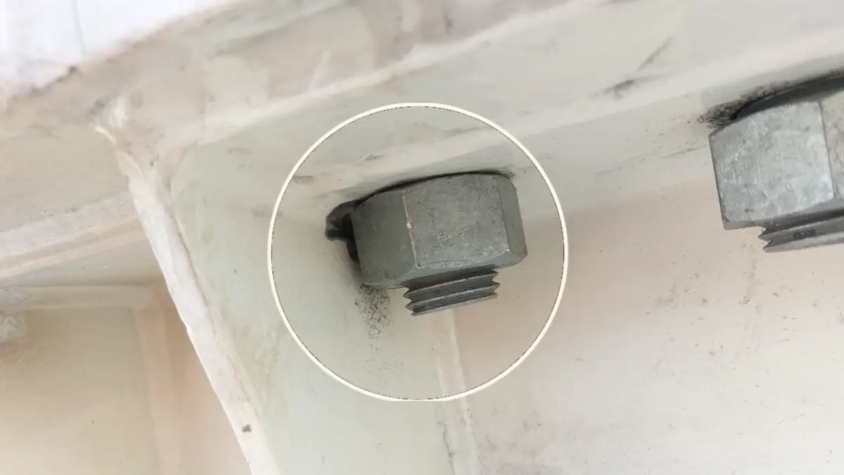 Close-up of motor base bolt clearance that may restrict accurate laser alignment.