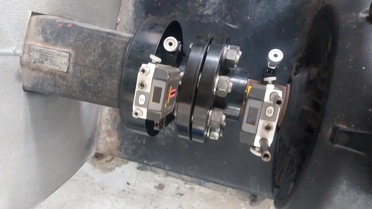 Laser alignment system installed on a hospital pump motor shaft to inspect alignment