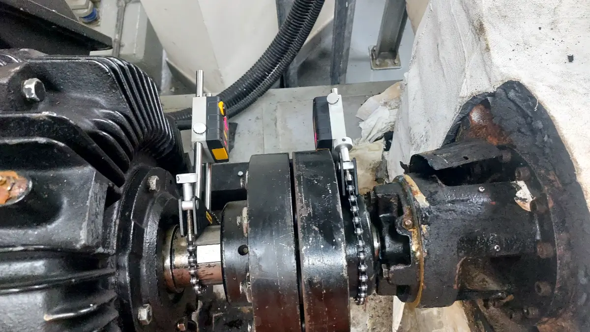 Laser measurement in progress for pump shaft alignment after bearing replacement
